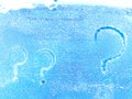 A question mark written in the snow. The cold frosty texture of the snow and the question mark. Background, place for