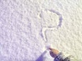 A question mark written in the snow and hand. The cold frosty texture of the snow and the question mark. Background Royalty Free Stock Photo