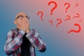 Question marks around a young man with glasses covering his face with his hands, psychological concept Royalty Free Stock Photo