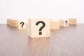 question marks blocks stand on wooden background with copy space Royalty Free Stock Photo