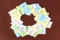 Question marks are drawn on small pieces of paper and folded into a circle with space for text. Royalty Free Stock Photo