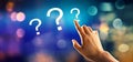 Question marks with hand pressing a button Royalty Free Stock Photo