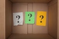 Question marks inside of a cardboard box Royalty Free Stock Photo