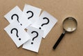 Question marks with a magnifying glass Royalty Free Stock Photo