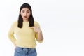 Questioned and confused young asian girl pointing herself and asking question, was mentioned in dialogue, chosen in team Royalty Free Stock Photo