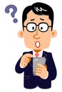 Questioning expression of a businessman wearing glasses operating a smartphone