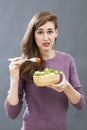 Questioning 20s girl questioning the taste of a mixed green salad Royalty Free Stock Photo