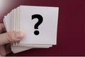 Questionmark sign on a white paper note on a red Royalty Free Stock Photo