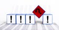 Questions and answers in business, finance. Cubes with question mark and exclamation points on statistics documents Royalty Free Stock Photo