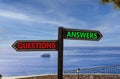 Questions and answers symbol. Concept word Questions Answers on beautiful signpost with two arrows. Beautiful blue sea sky clouds Royalty Free Stock Photo
