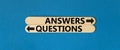 Questions and answers symbol. Concept word Questions Answers on beautiful wooden stick. Beautiful blue table blue background. Royalty Free Stock Photo