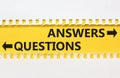 Questions and answers symbol. Concept word Questions Answers on beautiful yellow paper. Beautiful white paper background. Business Royalty Free Stock Photo