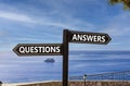 Questions and answers symbol. Concept word Questions Answers on beautiful signpost with two arrows. Beautiful blue sea sky clouds Royalty Free Stock Photo