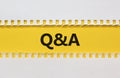 Questions and answers symbol. White and yellow paper. Words `Q and A, Questions and answers`. Beautiful yellow background. Royalty Free Stock Photo