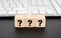 Questions Mark on wooden block and computer keyboard Royalty Free Stock Photo