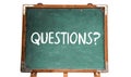 Questions? text word message in white chalk written on a green old grungy vintage wooden chalkboard or blackboard with frame Royalty Free Stock Photo