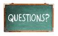 Questions? text word message in white chalk written on a wide green old grungy vintage wooden chalkboard or retro blackboard Royalty Free Stock Photo