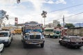 QUETZALTENANGO, GUATEMALA - MARCH 21, 2016: Colourful chicken buses, former US school buses, ride in Quetzaltenango cit