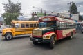 QUETZALTENANGO, GUATEMALA - MARCH 21, 2016: Colourful chicken buses, former US school buses, ride in Quetzaltenango cit