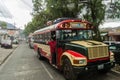 QUETZALTENANGO, GUATEMALA - MARCH 21, 2016: Colourful chicken buses, former US school buses, ride in Quetzaltenango cit