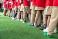 Queue of Asian kids in school uniform standing in line