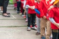 Queue of Asian kids in school uniform standing in line