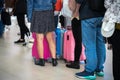 Queue of Asian people waiting at boarding gate at airport. Closeup.