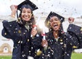 Queue the celebrations. Cropped portrait of two attractive young female students celebrating on graduation day. Royalty Free Stock Photo