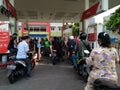 A queue of motorbikes filling up with gas Royalty Free Stock Photo