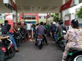 A queue of motorbikes filling up with gas Royalty Free Stock Photo