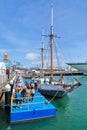 A queue of people boarding a sailing ship for a cruise Royalty Free Stock Photo