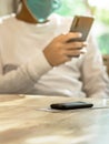 Queue Wireless Calling System Restaurant or Pager Customers System with invoice on table with blur image of man wear protective Royalty Free Stock Photo