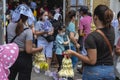 Quiapo, Metro manila, Philippines - A vendor hawks sampaguita garlands to people exiting the church during Good Friday