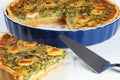 Quiche Florentine cut in slices in baking dish Royalty Free Stock Photo