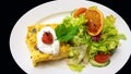 Quiche and salad topped by an orange slice, white saucer isolate Royalty Free Stock Photo