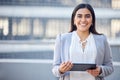 A quick breather for a non-stop grinder. a beautiful young. businesswoman using a digital tablet while standing outside. Royalty Free Stock Photo