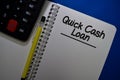 Quick Cash Loan write on a book isolated on Office Desk