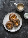 Quick cheese-curd rolls and coffee with cream on a dark background, top view. Delicious breakfast, brunch, snack