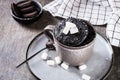 Quick chocolate cake mug with marshmallows on a plate on the table Royalty Free Stock Photo