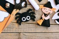 Quick Halloween crafts. Felt witch doll, spider decorations on a vintage wooden background. Needlework tools and materials