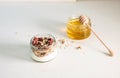 Quick healthy breakfast greek yogurt, honey, granola with dried berries and nuts in glass jar on stone table. Homemade granola par Royalty Free Stock Photo