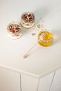 Quick healthy breakfast greek yogurt, honey, granola with dried berries and nuts in glass jar on stone table. Homemade granola par Royalty Free Stock Photo