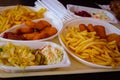 Quick lunch. French fries, fried nuggets and salads. Delicious fast food