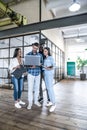 Quick meeting. Full length of young business people in smart casual wear working together and smiling while standing in the office Royalty Free Stock Photo