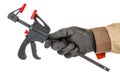 Quick release clamp in worker hand in black protective glove and brown uniform isolated on white background Royalty Free Stock Photo