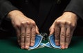 Quick shuffling of playing cards by the hands of an experienced dealer or croupier in a poker club on a green table with playing Royalty Free Stock Photo