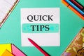 QUICK TIPS written on a turquoise background near bright stickers, notepads and markers