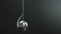 a sleek, kinetic pendulum dances in silence