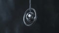 a sleek, kinetic pendulum dances in silence