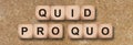 Quid pro quo printed on wooden cube